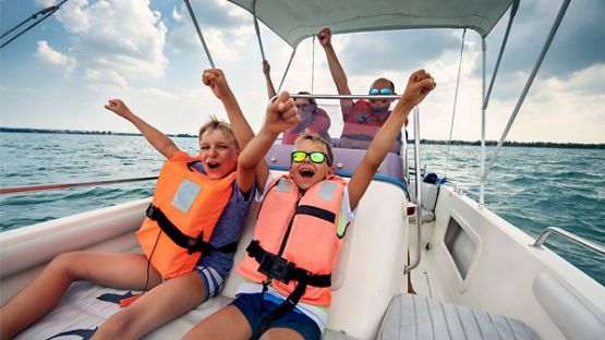 A family of four enjoying their time on the lake in a bowrider.